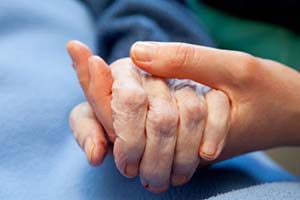 holding elderly person's hand